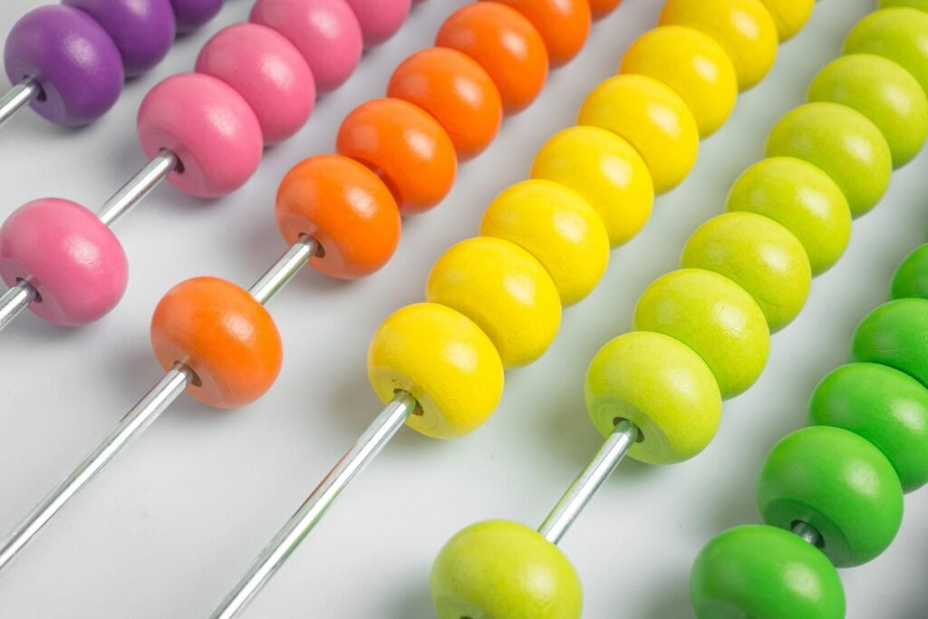Child learning basic number calculations using an abacus